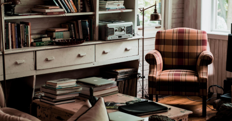 cozy room with sofa chair filled with books