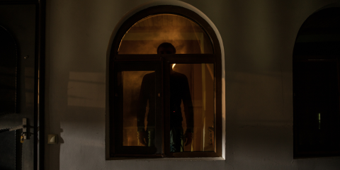 Man standing in the window, dark silhouette